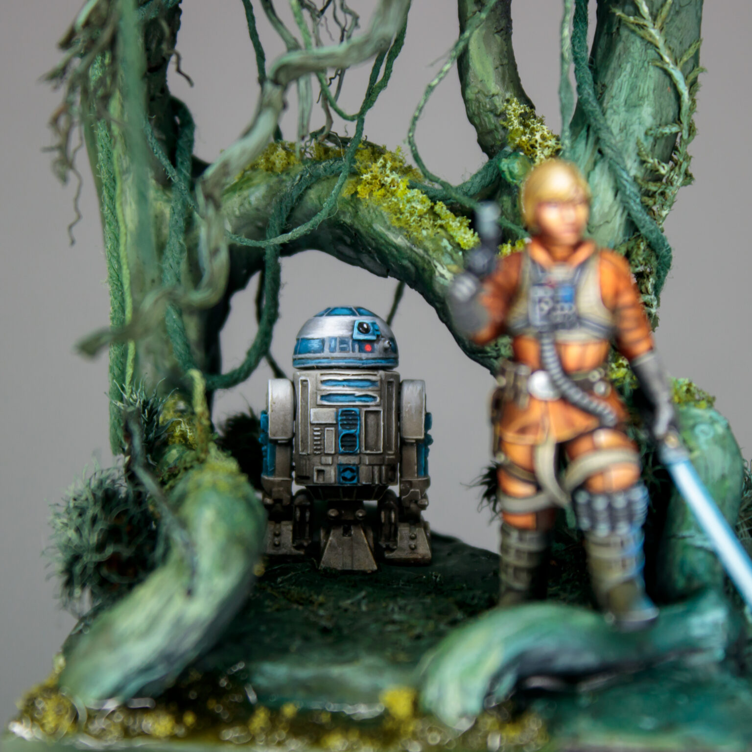 Figure of Luke Skywalker and R2D2 in Dagobah swamp.